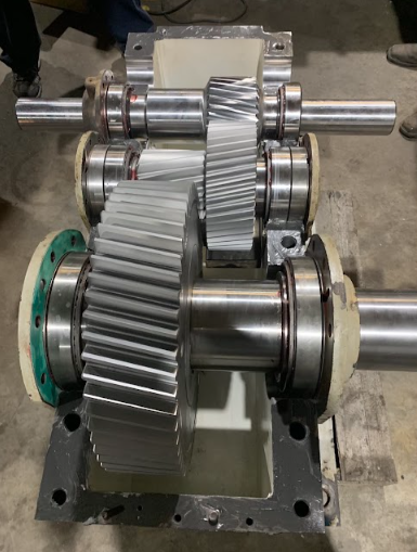 A hydraulic cylinder repair machine placed on the ground.