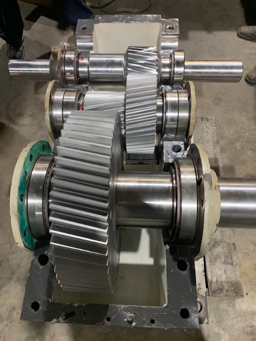 This image shows a multi-stage helical gearbox
